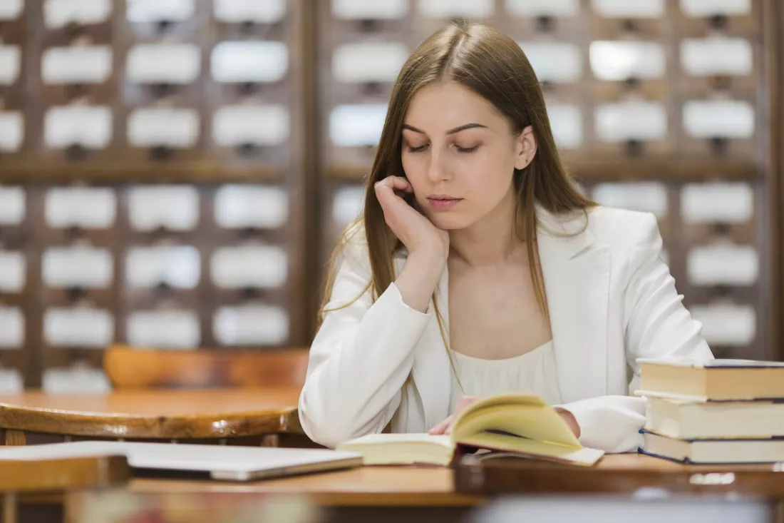 back-school-concept-with-woman-studying-library