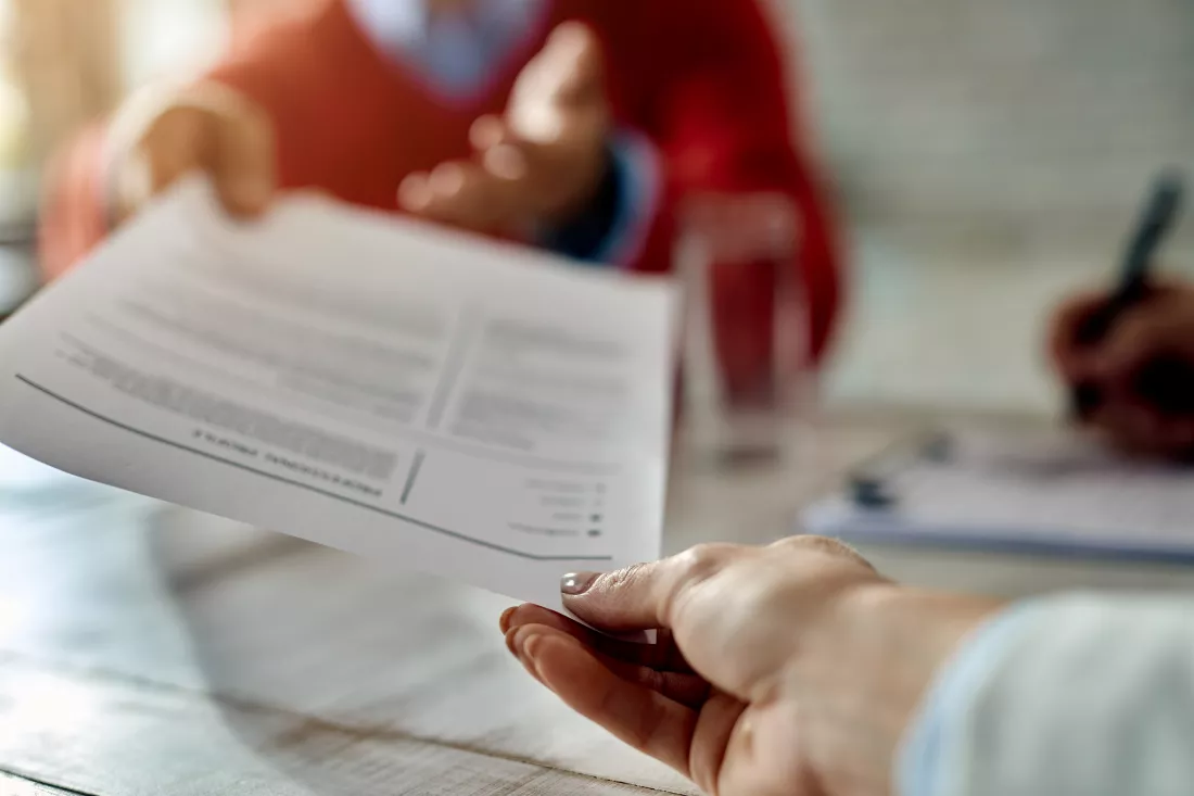 closeup-job-applicant-giving-his-resume-job-interview-office