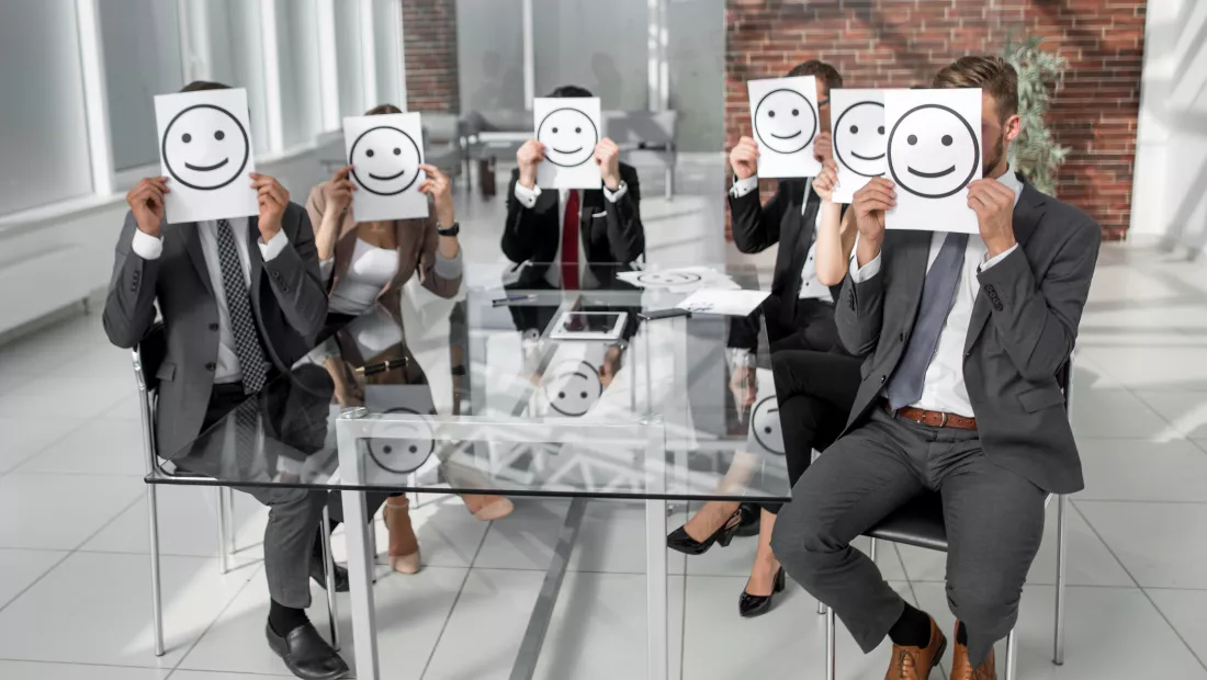 business-team-holding-paper-with-positive-smiley